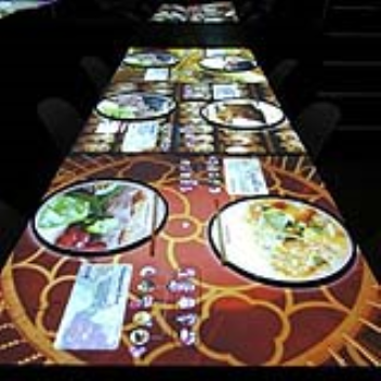 Touch-sensitive tabletops let visitors preview the food and look up services