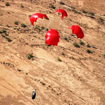 Auto-rotating parachute system for low-cost payload delivery