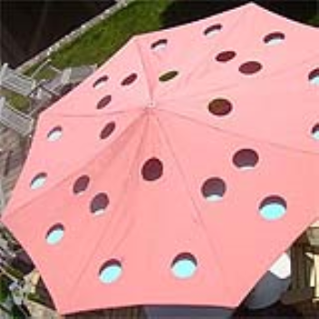 Parasol with holes for different colour effects