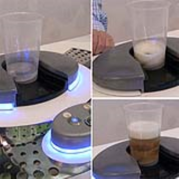 Beverage dispenser that fills cups from the bottom